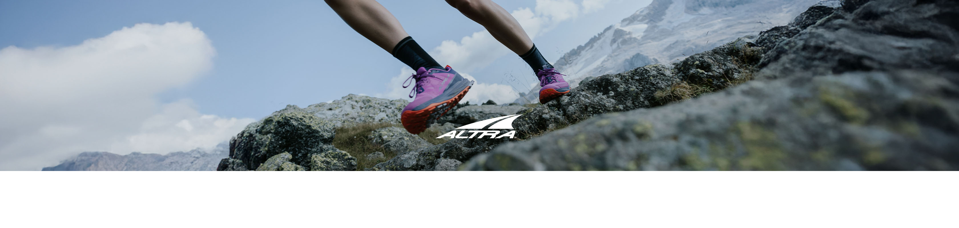 Shop Altra running shoes. A runner wearing Lone Peak running shoes on a trail path