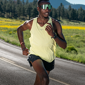 Shop race day essentials. A man in yellow vest runnin on the road